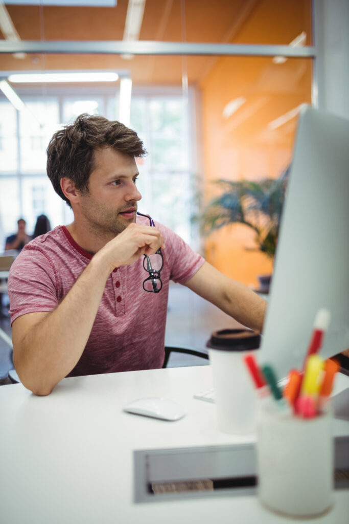 Graphic designer checking print artwork on screen