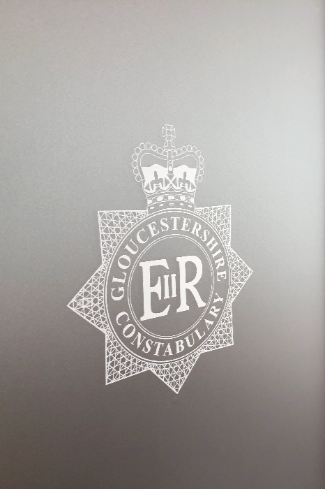 Close-up of a frosted vinyl Gloucestershire Constabulary crest on glass