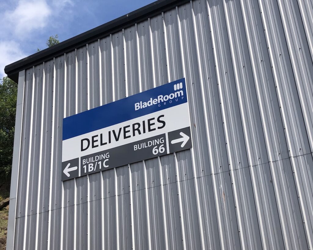 Printed directional deliveries sign on a BladeRoom building