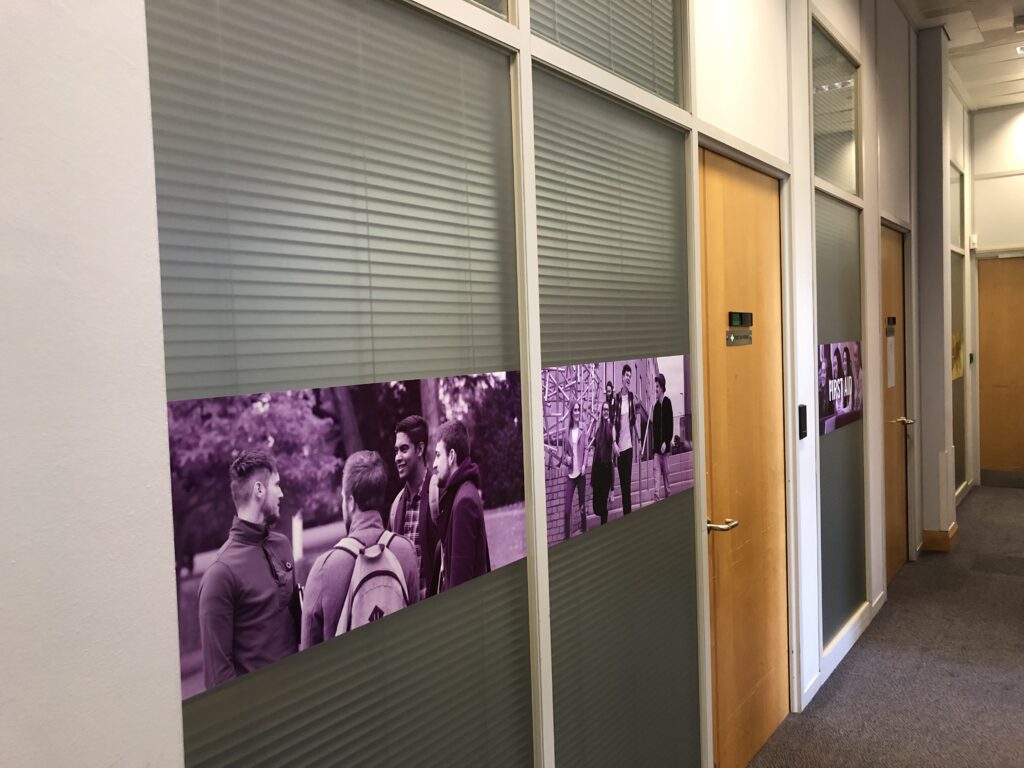 Printed manifestation graphic along an office glass partition
