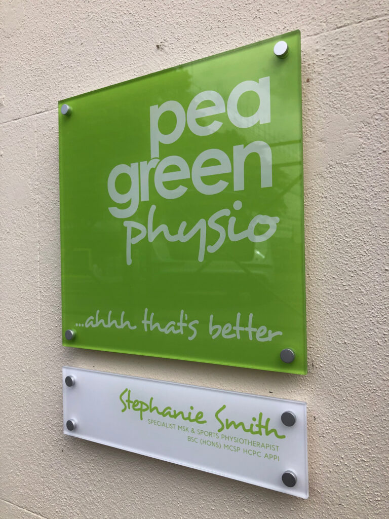 Green acrylic sign for Pea Green Physio with a name plate below, sign making in Cheltenham