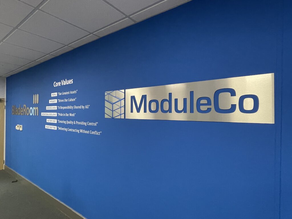 Office wall graphics with brushed metal ModuleCo logo and company values