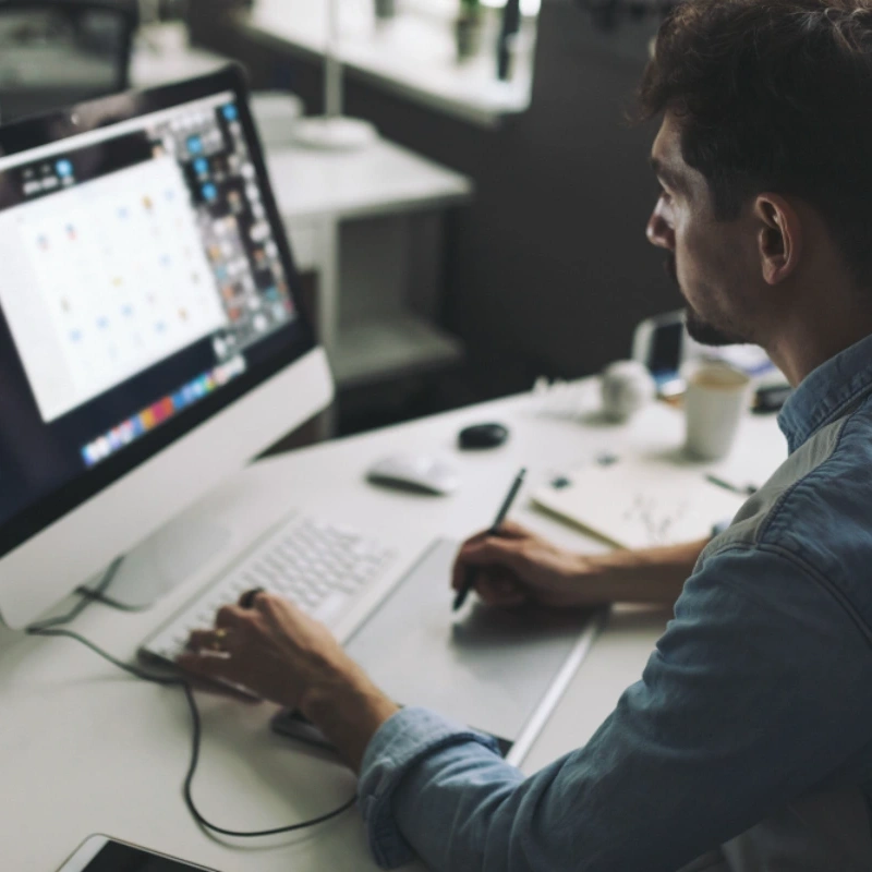 Designer creating print artwork at a computer, print design in Cheltenham